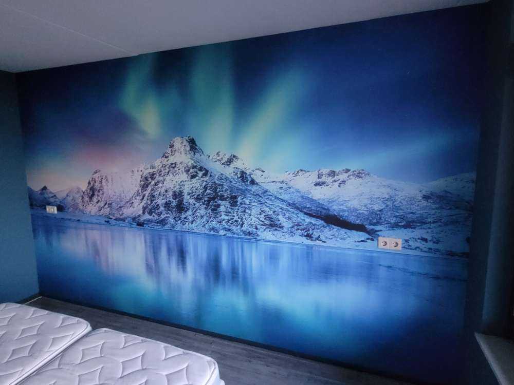 Północne światła nad zamarzniętym oceanem i górami